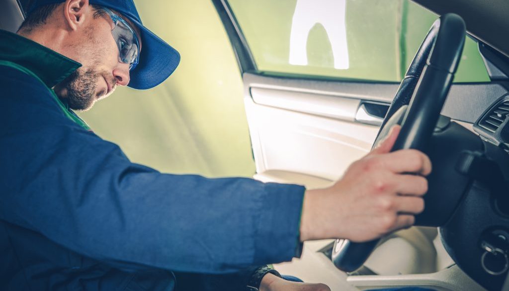 Pink Slips eSafety Inspection for Car Registration renewal Mechanic examining car interior