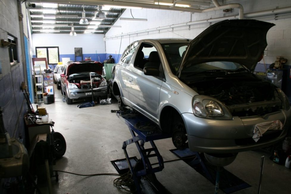 RL Auto Gladesville Interior Section of Workshop with Car on Hoist in foreground