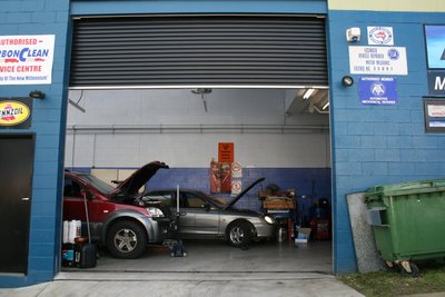 R & L Automotive Mechanics Side Street View Open Roller Door with Cars in Workshop